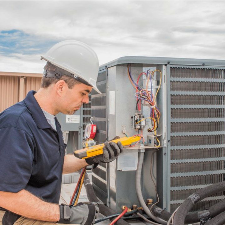 Mount Brydges Heating & Cooling technician servicing a furnace in a Middlesex County home